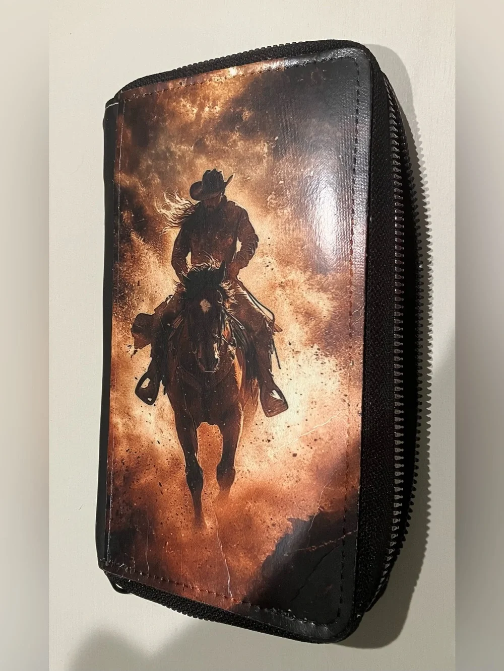 Western-themed zip-around wallet cowboy riding horse sunset
